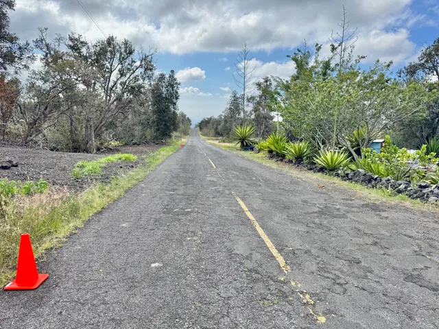 a view of a road with a backyard