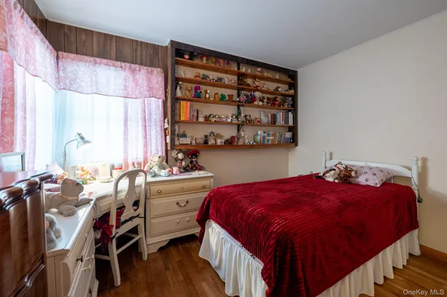 a bedroom with a bed and a book shelf