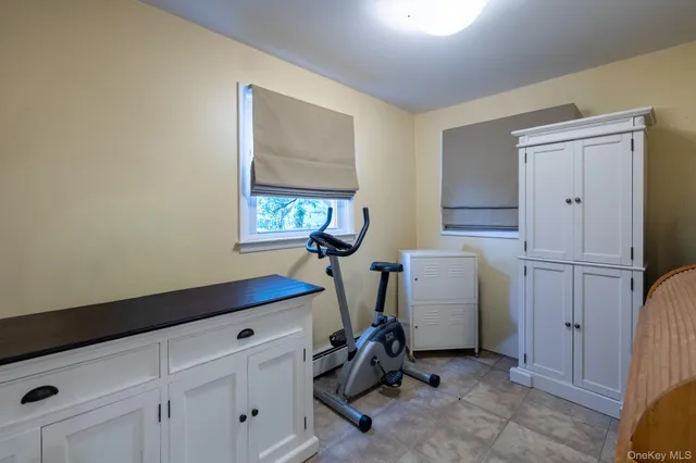 a room with a window and a dresser