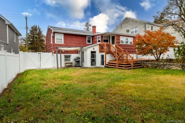 a front view of a house with a yard table and chairs