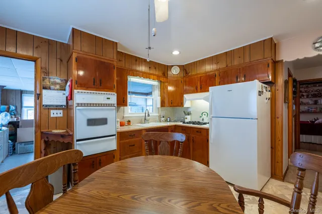 a kitchen with stainless steel appliances a refrigerator and a stove top oven