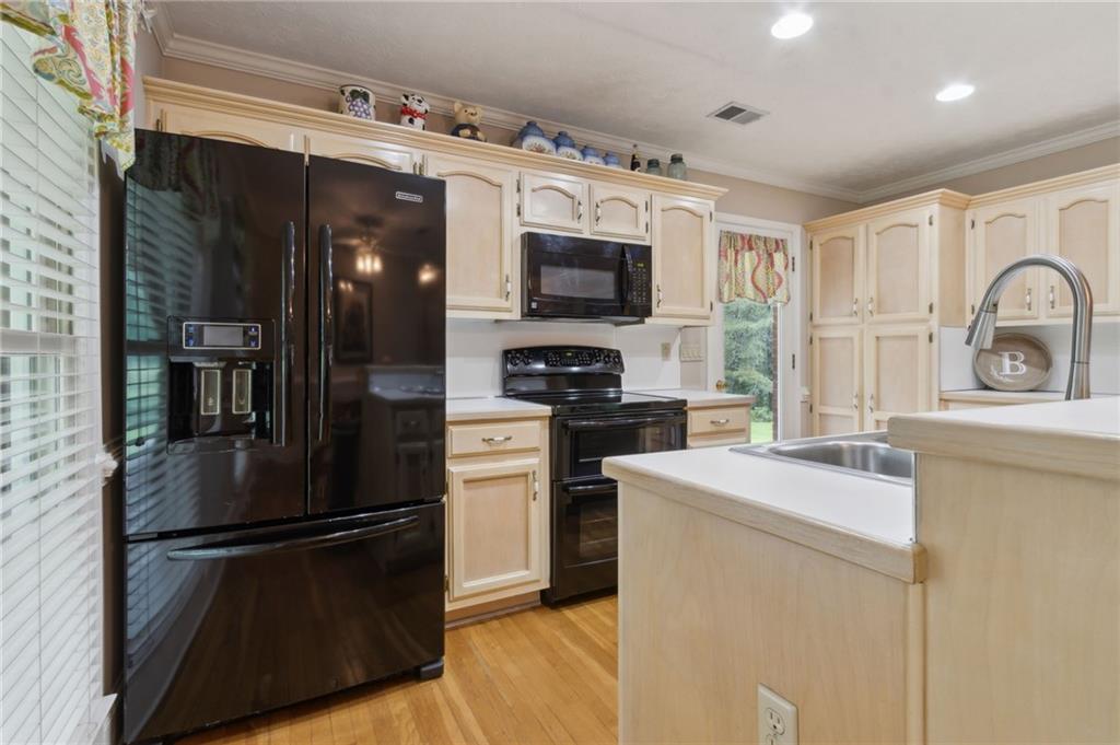 83 Russell Road Lawrenceville, GA 30043 - Photo 15 of 67 a kitchen with stainless steel appliances a refrigerator stove microwave and sink