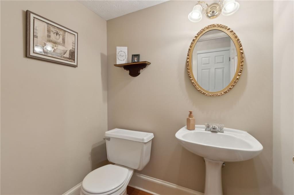 83 Russell Road Lawrenceville, GA 30043 - Photo 22 of 67 a bathroom with a toilet and a sink