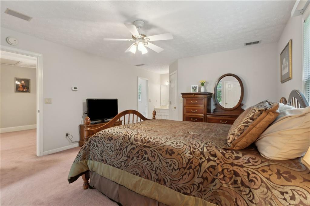 83 Russell Road Lawrenceville, GA 30043 - Photo 35 of 67 a bedroom with a bed and a flat screen tv