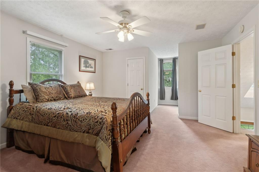 83 Russell Road Lawrenceville, GA 30043 - Photo 36 of 67 a bed room with a bed and a chandelier
