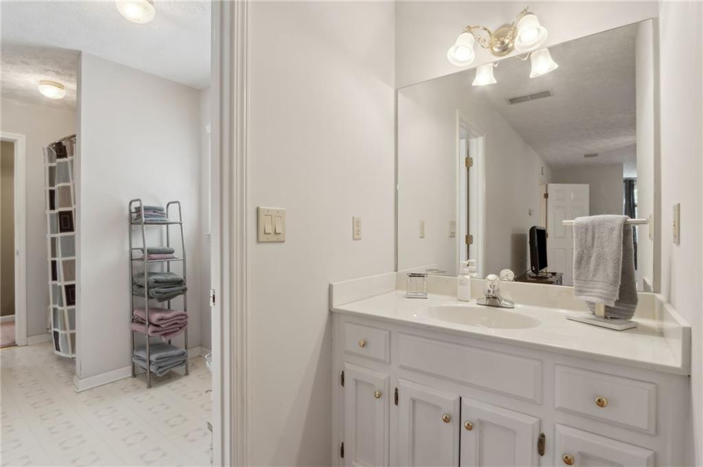 83 Russell Road Lawrenceville, GA 30043 - Photo 37 of 67 a bathroom with a double vanity sink a vanity and a mirror