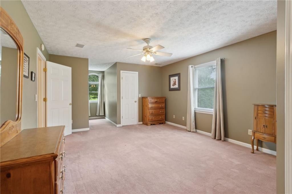 83 Russell Road Lawrenceville, GA 30043 - Photo 40 of 67 a view of a livingroom with a chandelier fan and windows