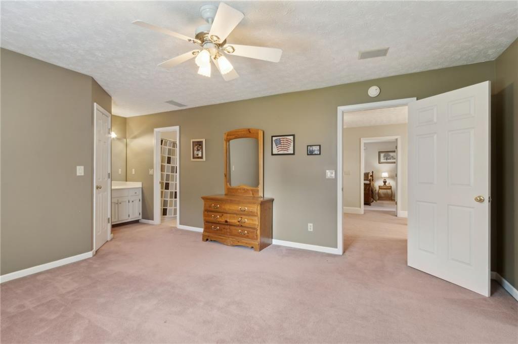 83 Russell Road Lawrenceville, GA 30043 - Photo 41 of 67 a view of a livingroom with a chandelier fan and windows