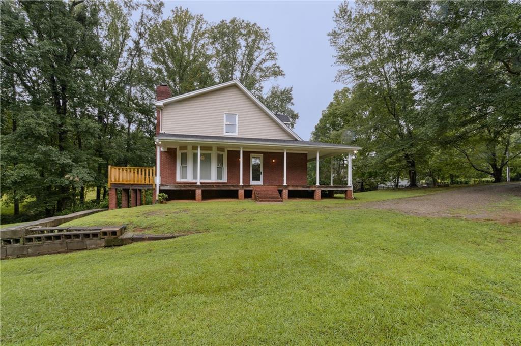 83 Russell Road Lawrenceville, GA 30043 - Photo 55 of 67 a view of a house with a yard and sitting area