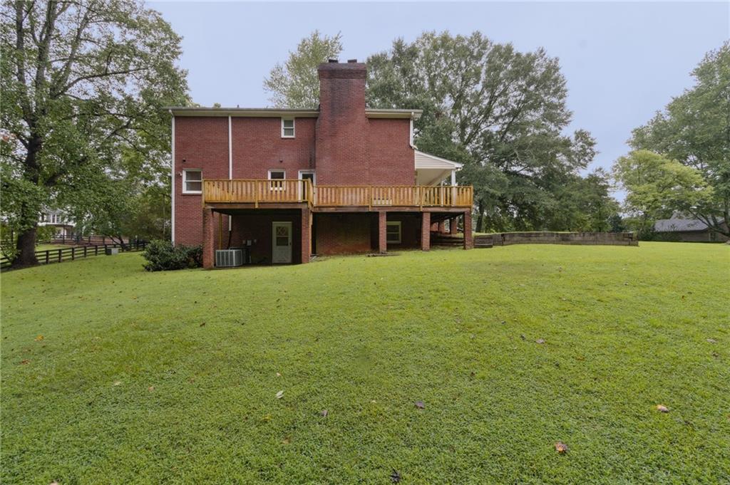 83 Russell Road Lawrenceville, GA 30043 - Photo 57 of 67 a view of a house with a yard and sitting area