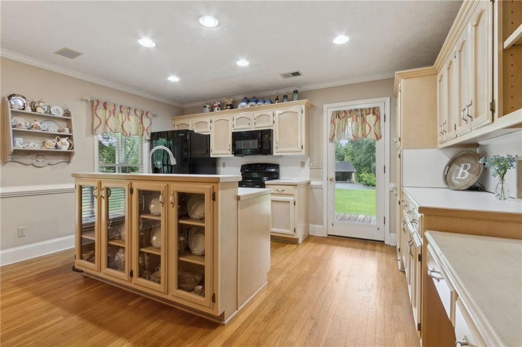 83 Russell Road Lawrenceville, GA 30043 - Photo 10 of 67 a living room with stainless steel appliances furniture a flat screen tv and a kitchen view