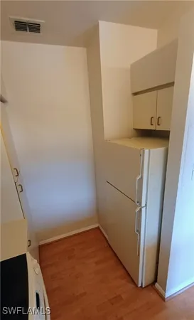 a view of storage and utility room with a refrigerator