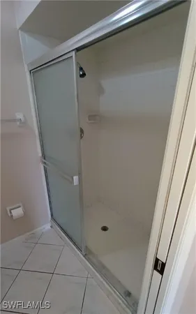 a bathroom with a glass shower door
