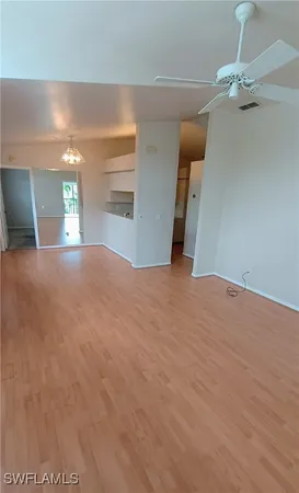 a view of empty room with windows and fireplace