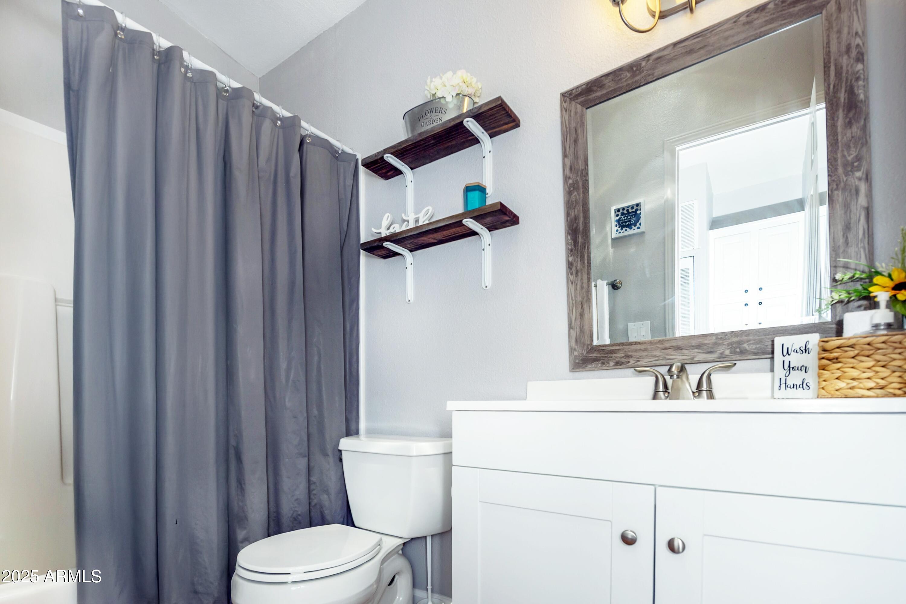 12320 Jacobs Road Mayer, AZ 86333 - Photo 21 of 37 a bathroom with a toilet a sink and mirror