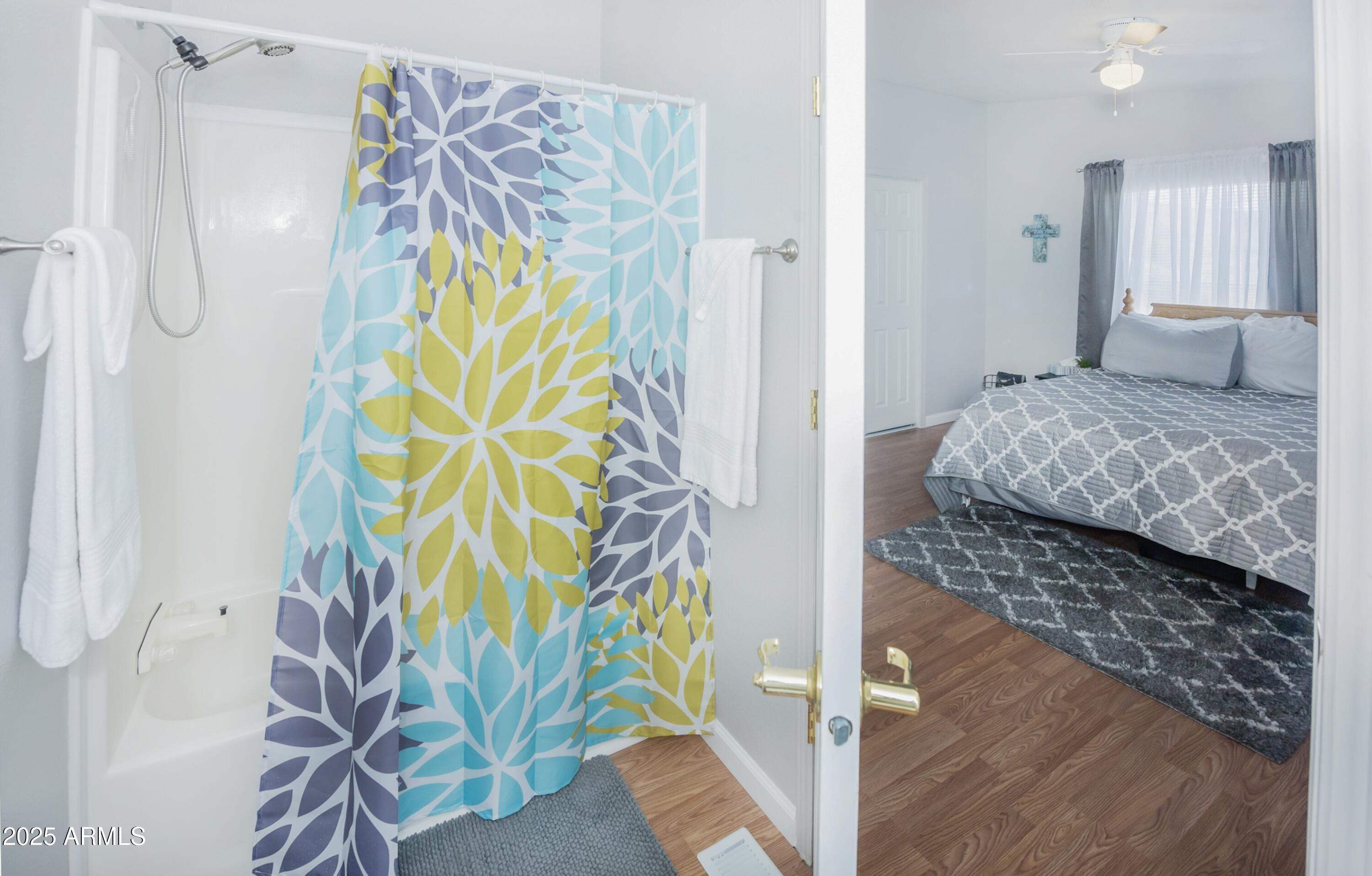 12320 Jacobs Road Mayer, AZ 86333 - Photo 23 of 37 a bedroom with a bed and a chandelier