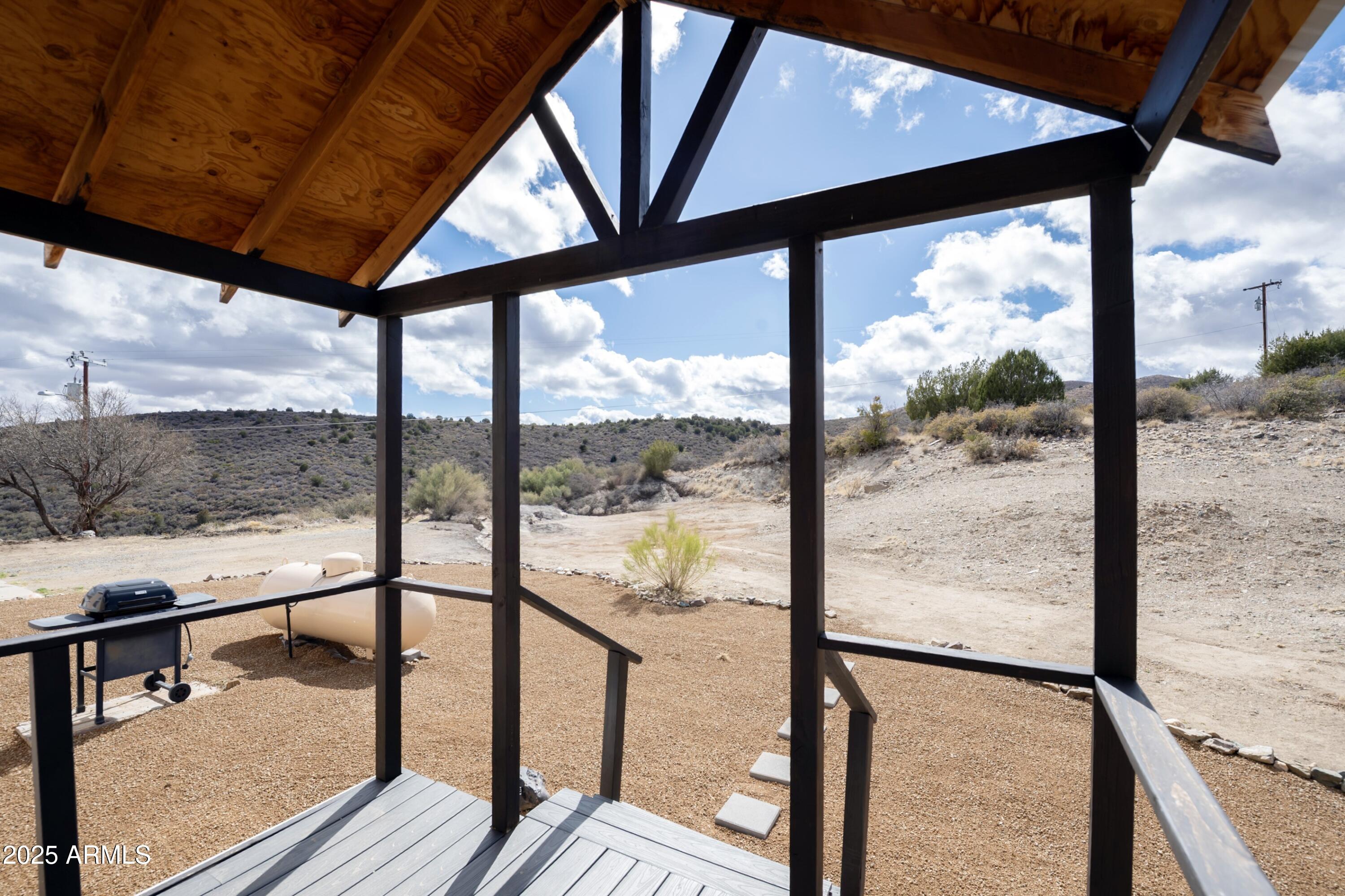 12320 Jacobs Road Mayer, AZ 86333 - Photo 31 of 37 a view of a porch with wooden floor and furniture