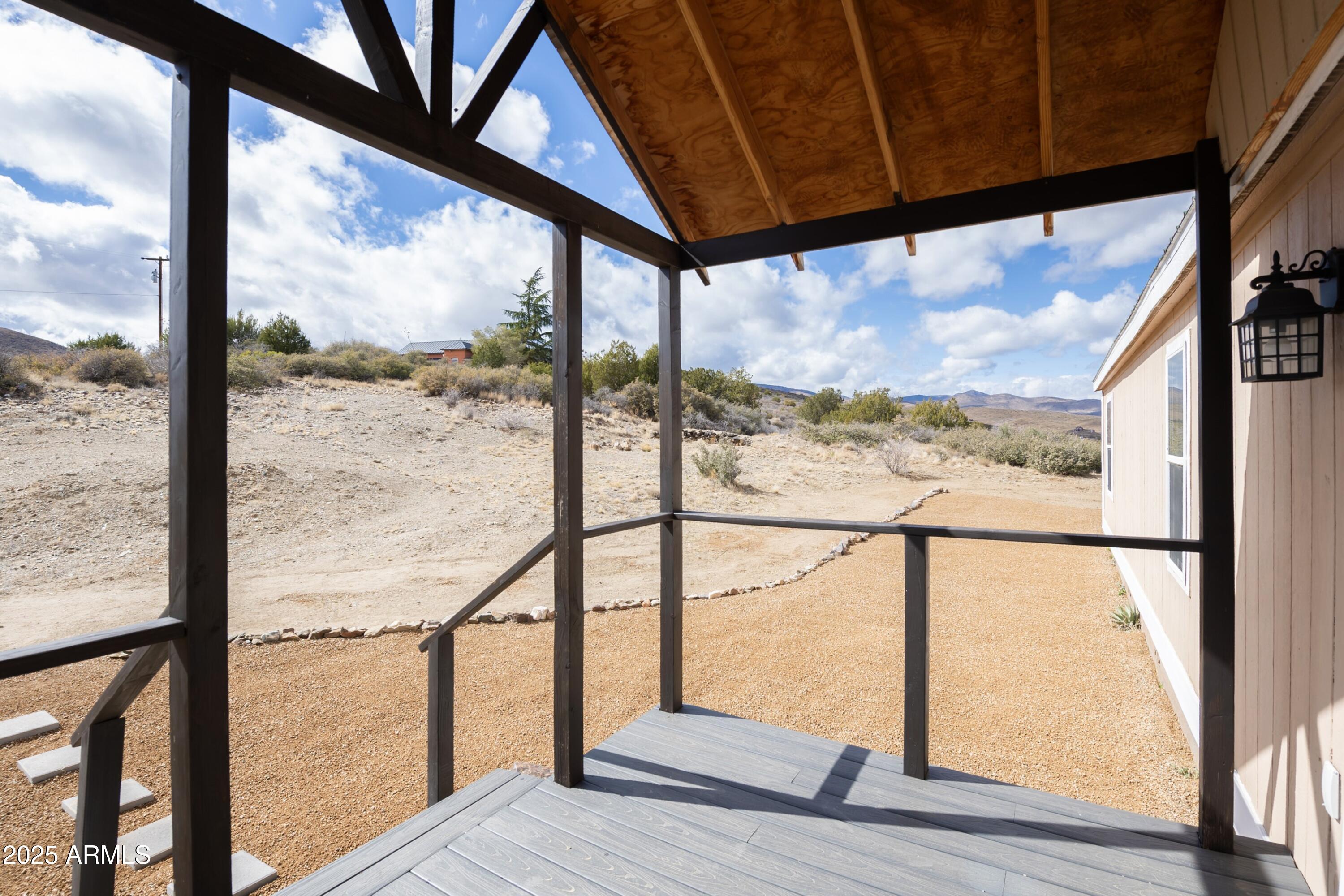 12320 Jacobs Road Mayer, AZ 86333 - Photo 32 of 37 a view of an empty room with wooden floor and wooden floor