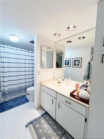 a bathroom with a sink mirror and toilet