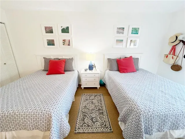 a bedroom with bed and wall painting