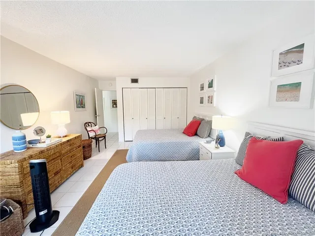 a bedroom with a large bed and a couch