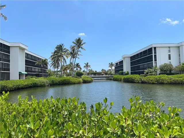 an aerial view of a house with a yard and lake view