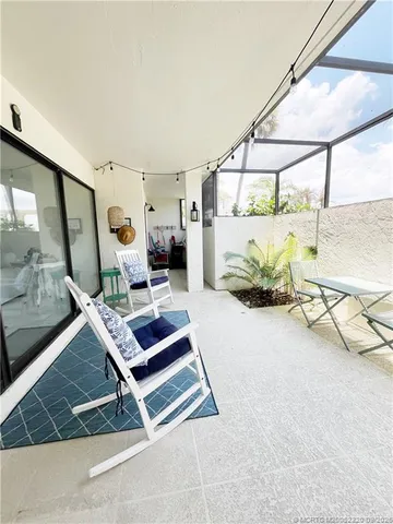 a reading room with furniture and next to a window