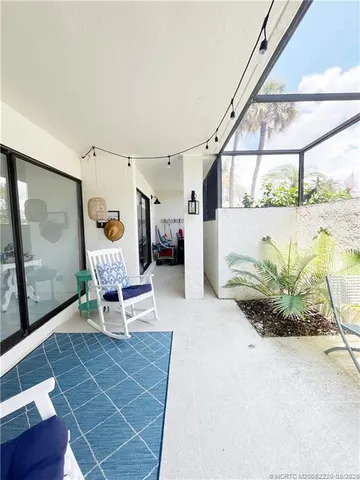 a dining room with furniture and a floor to ceiling window