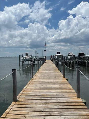 a view of outdoor space with swimming pool and trees in the background