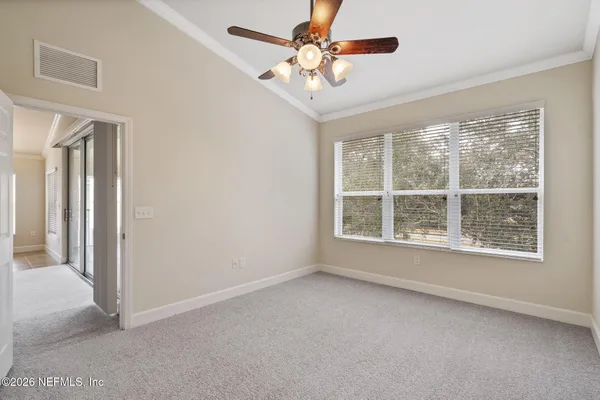 a view of a livingroom with a ceiling fan and refrigerator
