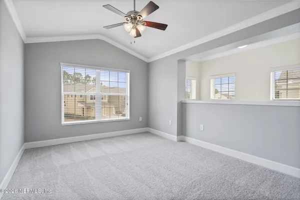 a view of a kitchen with a microwave and a ceiling fan