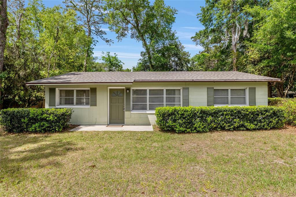 1410 Northwest 55th Street Gainesville, FL 32605 - Photo 1 of 1 front view of a house that has a yard