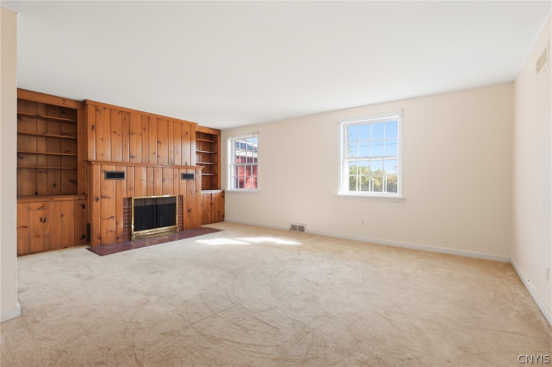 7779 Bell Road North Rome, NY 13440 - Photo 6 of 38 Rich wood paneling surrounds a classic fireplace in this warm and welcoming living area.