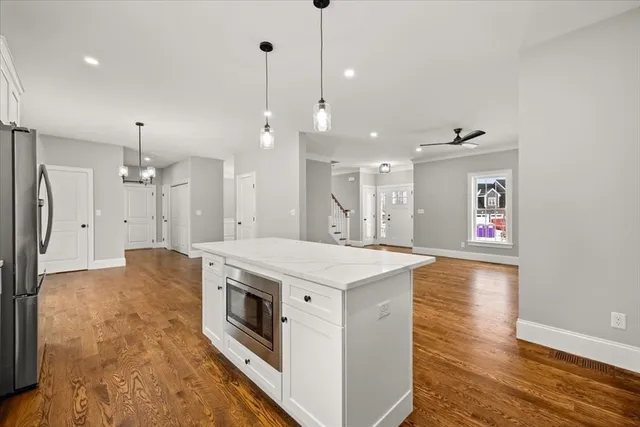 a large kitchen with stainless steel appliances granite countertop a stove and a refrigerator