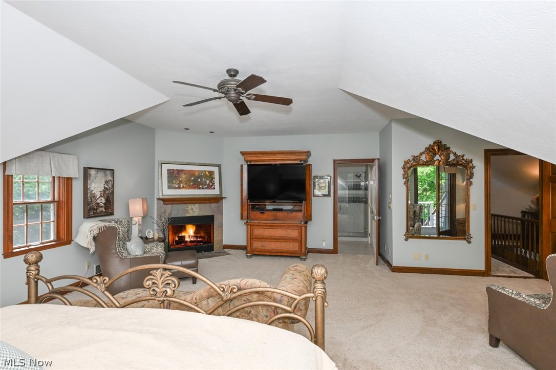 3530 Brush Road Richfield, OH 44286 - Photo 17 of 35 Carpeted bedroom featuring lofted ceiling, ensuite bathroom, multiple windows, and ceiling fan
