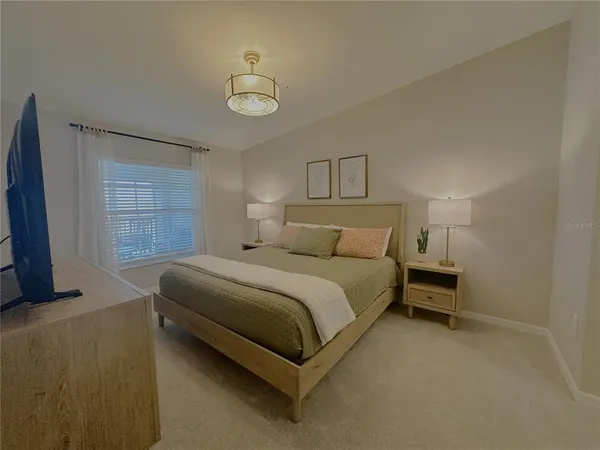 a bedroom with a bed and window