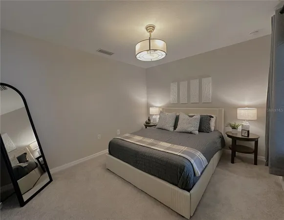 a bedroom with a bed and a mirror