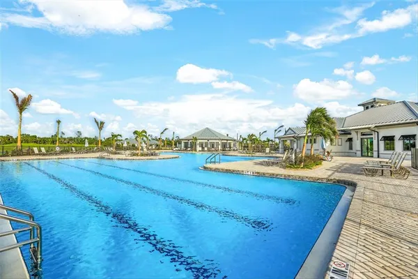 a view of a swimming pool and an outdoor seating