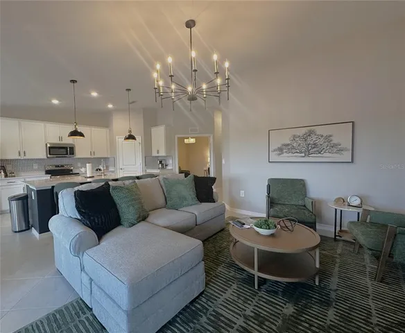 a living room with furniture and a chandelier