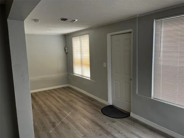 a view of wooden floor and windows in a room