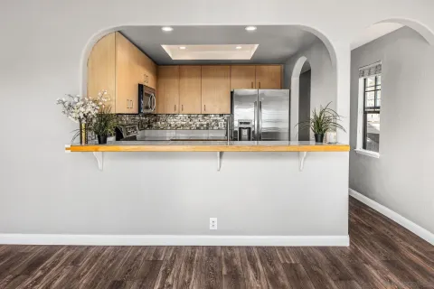 a kitchen with appliances a sink and cabinets