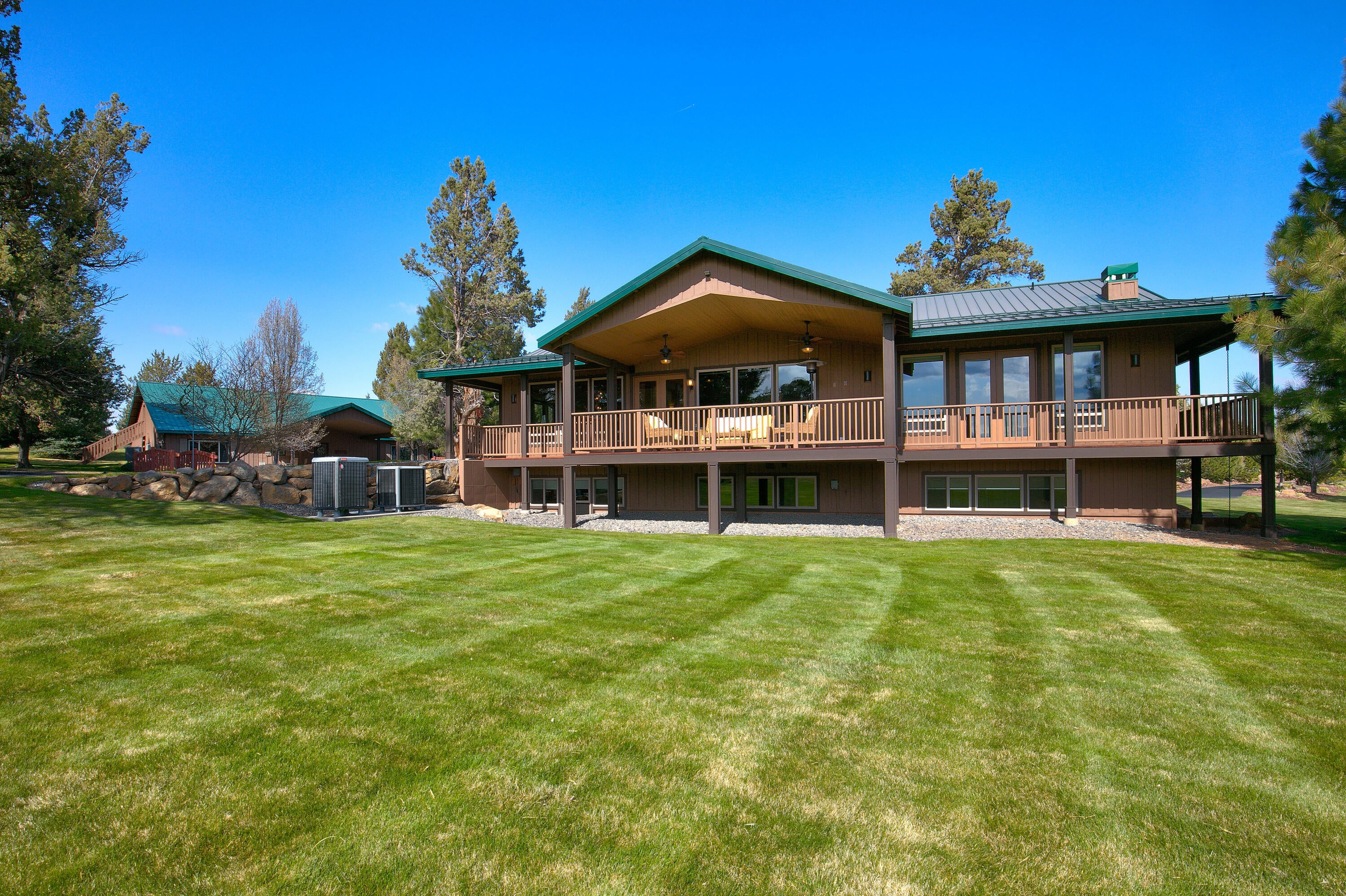 69015 Hurtley Ranch Road Sisters, OR 97759 - Photo 56 of 88 West-facing wrap-around deck with mountain views over the lush landscaping