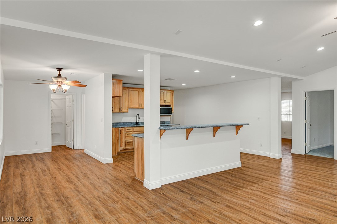 1810 Pinto Road Henderson, NV 89002 - Photo 17 of 53 An inviting open-concept layout connects the kitchen to a spacious living area, complete with a breakfast bar.