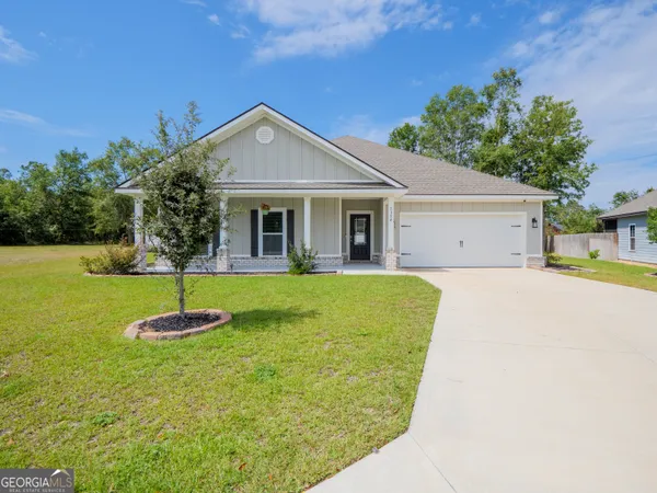 a front view of house with yard and green space