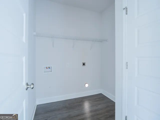 an empty room with a window and a ceiling fan