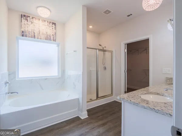 a bathroom with a bathtub and a window