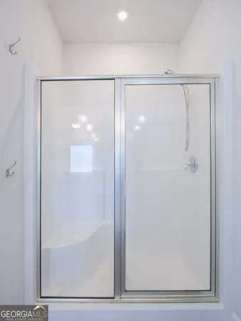 a bathroom with a granite countertop double vanity sink a mirror and a