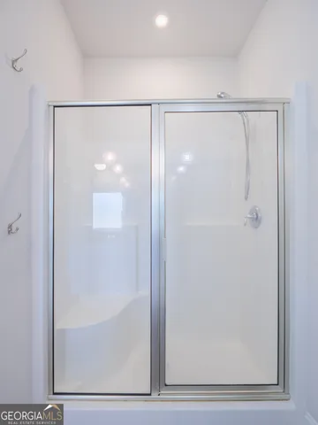 a bathroom with a granite countertop double vanity sink a mirror and a