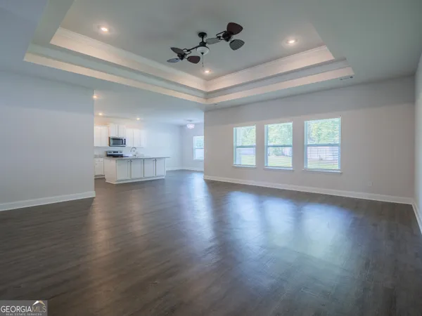 a view of wooden floor and windows in a room