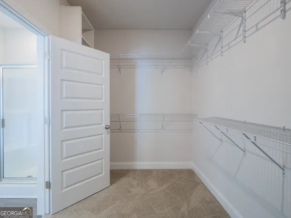 a white toilet sitting next to a white wall